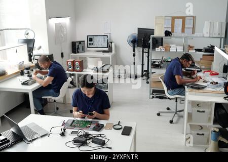 Engineers Working on Electronics Prototypes in Office Stock Photo