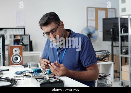 Working on Electronic Circuit Board in Tech Lab Stock Photo