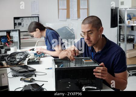 Fixing Computer Hardware in Technology Workshop Stock Photo