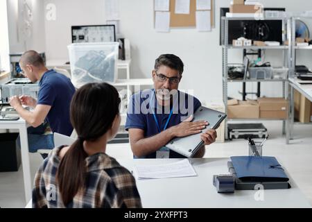Engaging Meeting in Modern Office Workspace Involving Technology Stock Photo