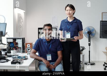 Smiling Colleagues Collaborating on Technology Project Stock Photo