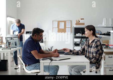 Collaborating in Modern Office Setting With Tech Gadgets Stock Photo