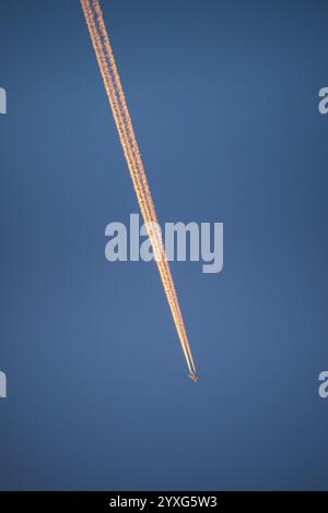 Contrails in the sky from a passenger jet plane. Stock Photo