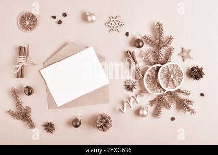 The template is a blank paper and an envelope with a place for text on a beige background with various natural decorations for Christmas. Flat top vie Stock Photo