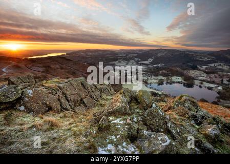 Beautiful sunrise over Windermere overlooking view of Loughrigg Tarn in The Lake District, UK. Stock Photo