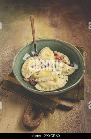 Dumplings, with fried prosciutto, a traditional dish of Polish cuisine, dumplings, top view, close-up, without people Stock Photo
