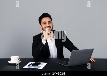 Confident Arab businessman smiles in a sleek corporate studio Stock Photo