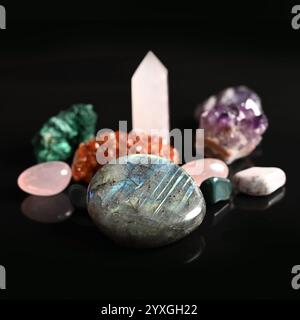 Set of different colorful semi-precious stones on a black background, close-up Stock Photo