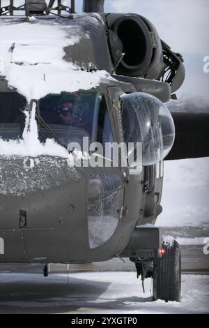 A utility Blackhawk (UH-60) helicopter about to start up for training some training after a snow squall hits. Air Resources helicopter in Utah Stock Photo