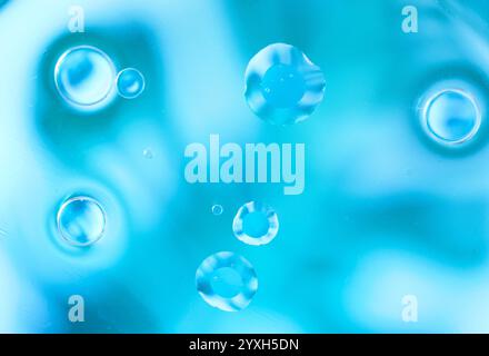 Vibrant abstract blue background featuring floating water bubbles and soft light reflections. High-quality close-up with clean, modern design. Copy sp Stock Photo