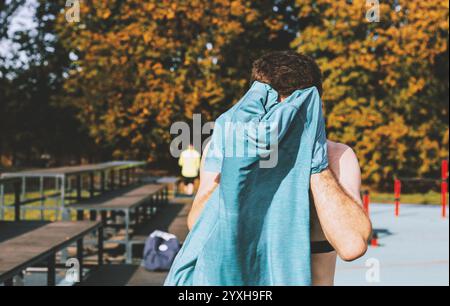 young athlete doing pull-ups on an outdoor sports ground Stock Photo