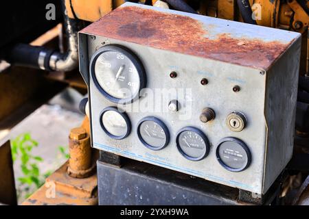 Vintage panel control dashboard of the old engine, Engine Control panel box and pressure gauge indicator of water pumping unit. Stock Photo