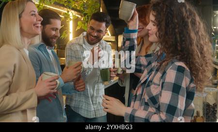 Happy multiracial group friends team mates freelance co-workers students colleagues joyful business men women diverse girls guys dancing male female Stock Photo