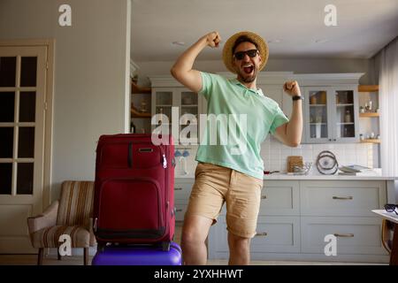 Happy man tourist with packed luggage suitcases Stock Photo