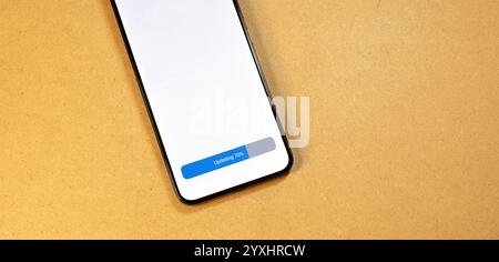 Smartphone OS update in progress, 70% completed on modern mobile device, application software screen with progress bar, technology concept for app ins Stock Photo