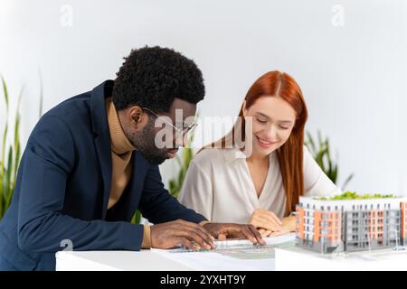 Colleagues in the office working together and looking involved Stock Photo