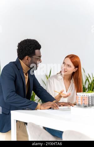 Colleagues in the office working together and looking involved Stock Photo