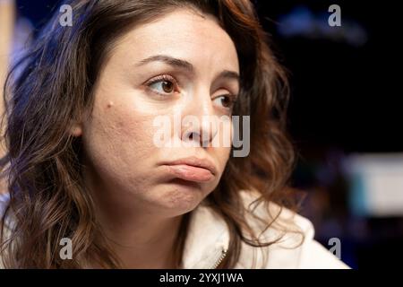 Computer scientist pouting while doing software quality assurance, finding major errors in source code. Close up of sad technician upset after inspecting coding on computer and seeing many issues Stock Photo