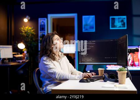 System administrator looking at AR visualization to fix vulnerabilities in software. Cybersecurity specialist using computer to patch security exposures using augmented reality tech Stock Photo
