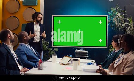 Startup team using greenscreen interactive board in a strategy workshop meeting, working together to improve their skills and performance. Corporation employees prepare for collaboration. Camera B. Stock Photo