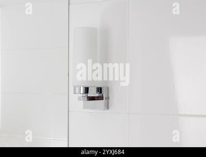 Modern Bathroom Wall Light Fixture on White Tile Stock Photo