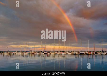 Rainbow and dramatic sky over harbor, Traverse City, Michigan, USA Stock Photo