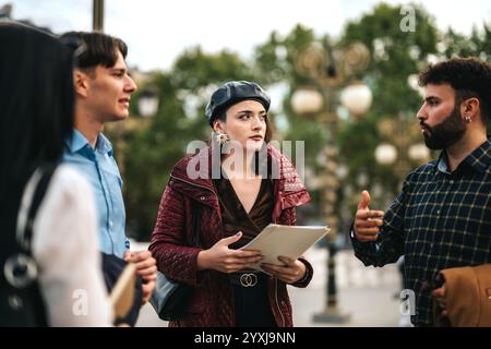 Young professionals engaged in a lively outdoor discussion Stock Photo