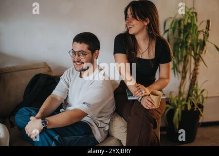 Two students enjoying a break and relaxing in a cozy setting Stock Photo
