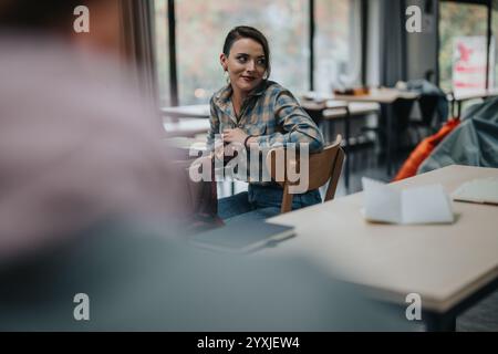 Student engaged in classroom discussion with peers Stock Photo