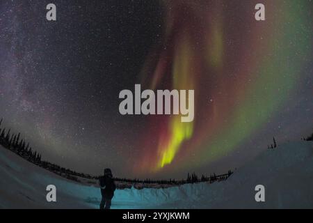 Observer watching an aurora borealis in Churchill, Manitoba, Canada. Stock Photo