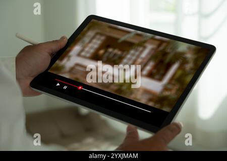 Man watching online videos on Tablet Movie streaming app  at home Stock Photo
