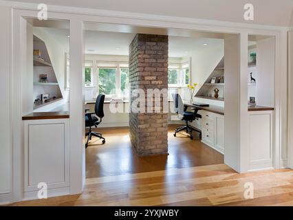 Very nice home office with two built-in desks and wood trim around entrance Stock Photo