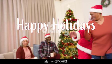 Image of happy holidays text over diverse senior friends dancing at christmas at home. Chirstmas, celebration and tradition concept digitally generate Stock Photo