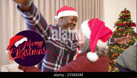Image of merry christmas text over diverse senior friends dancing at christmas at home. Chirstmas, celebration and tradition concept digitally generat Stock Photo