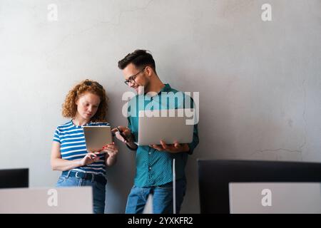 Happy business colleagues using a digital tablet, laptop in a boardroom. Working together as a team. Stock Photo