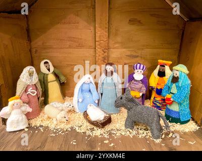 A crocheted Christmas nativity scene depicting the birth of Jesus in a ...
