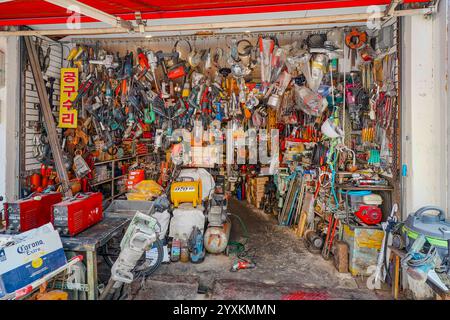 An interior view of a hardware store packed with various tools and supplies, reflecting a mix of organization and chaos. Stock Photo