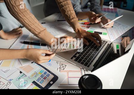 Creative UX UI Design Process with Team Collaborating on Mobile App Interface Prototypes and Wireframes Stock Photo