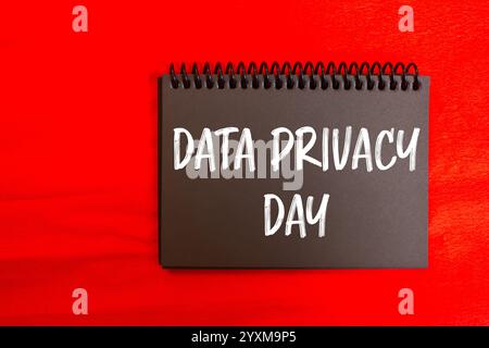 Data privacy day message written on black notebook page with red background. Conceptual data privacy day symbol. Copy space. Stock Photo