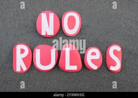 No rules, creative slogan composed with hand painted red colored stone letters over black volcanic sand Stock Photo