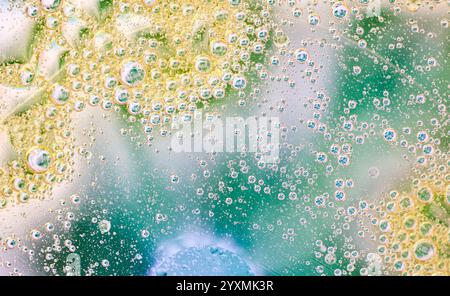 Abstract background of oil and water bubbles with soft green, yellow, and blue tones. Ideal for creative designs, modern visuals, and science-related Stock Photo