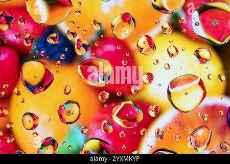 Splash water drops on transparent glass with multi color background. Stock Photo