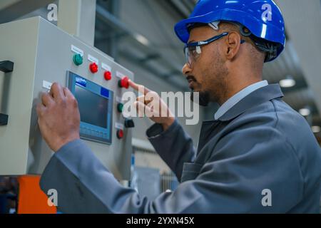 African American professional, a factory engineer updating industrial control panel. Modern industry, people, and automating concepts. Stock Photo