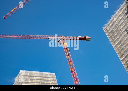 Tower cranes against a blue sky Stock Photo