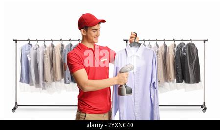 Dry cleaner ironing shirts with a hand steam iron isolated on white background Stock Photo