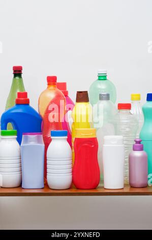 a range of empty plastic containers and bottles for recycling on shelf Stock Photo