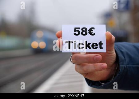 Bavaria, Germany - 17 December 2024: Symbolic image for the planned price increase of the Deutschlandticket to 58 euros from 2025. The image illustrates the new cost structure in local public transport and sheds light on the future financial challenges for commuters and travelers in Germany .FOTOMONTAGE *** Symbolbild für die geplante Preiserhöhung des Deutschlandtickets auf 58 Euro ab dem Jahr 2025. Das Bild verdeutlicht die neue Kostenstruktur im öffentlichen Nahverkehr und wirft ein Licht auf die zukünftigen finanziellen Herausforderungen für Pendler und Reisende in Deutschland .FOTOMONTAGE Stock Photo