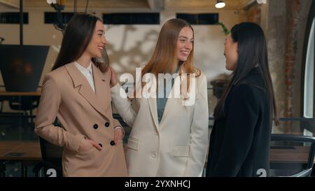 Happy smiling laughing joyful positive friendly business women people colleagues females multiracial multiethnic girls businesswomen diversity Stock Photo