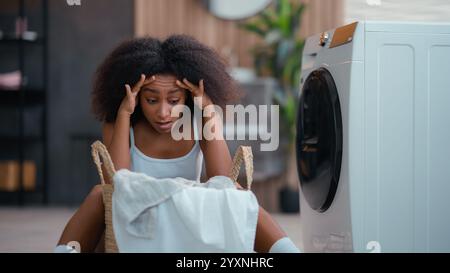Angry sad woman upset irritated tired annoyed frustrated African American girl ethnic female biracial housewife exhausted with homework dirty cloth Stock Photo