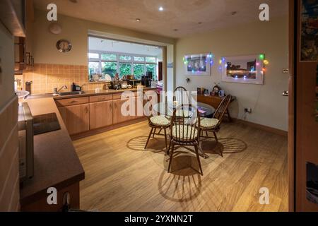 Large family kitchen with wooden effect floor. Stock Photo